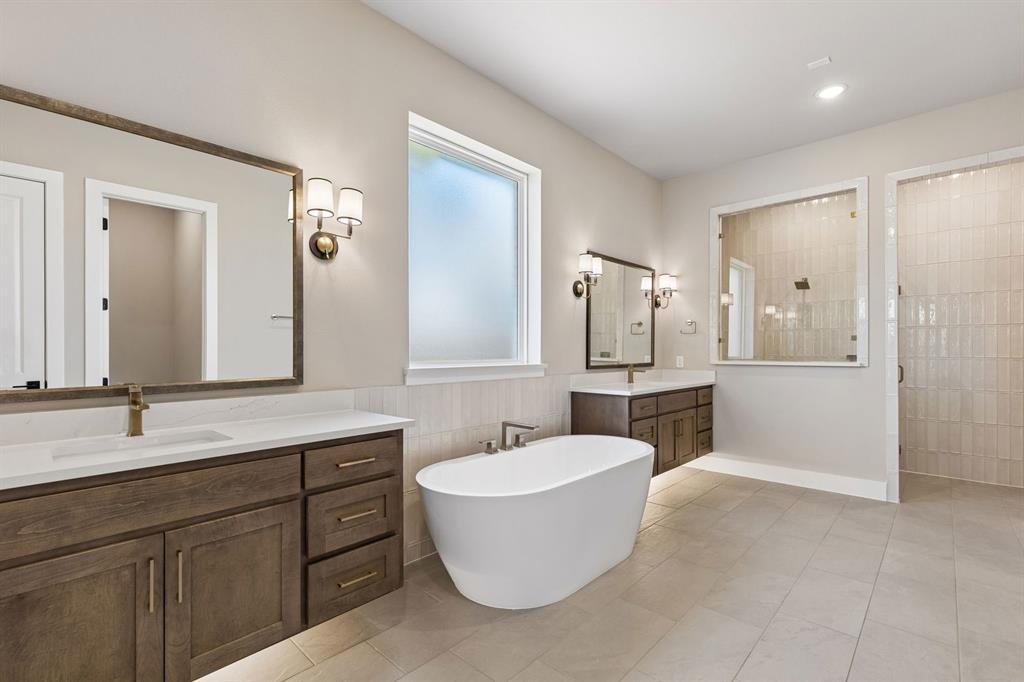 4512 Meander Way Prosper, TX 75078 - Photo 20 of 40 a bathroom with a tub sink shower and mirror
