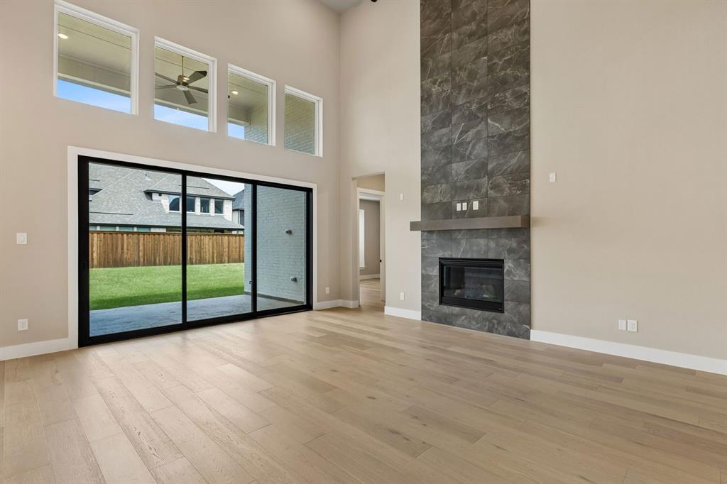 4512 Meander Way Prosper, TX 75078 - Photo 2 of 40 a view of an empty room with a fireplace and a window