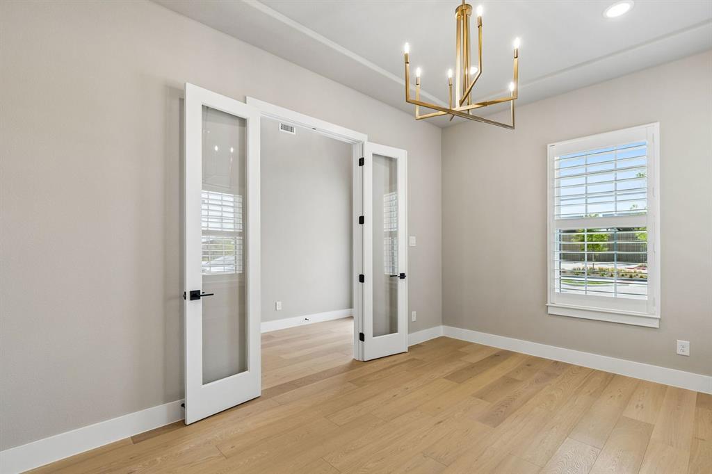 4512 Meander Way Prosper, TX 75078 - Photo 22 of 40 a view of a livingroom with a chandelier fan and windows
