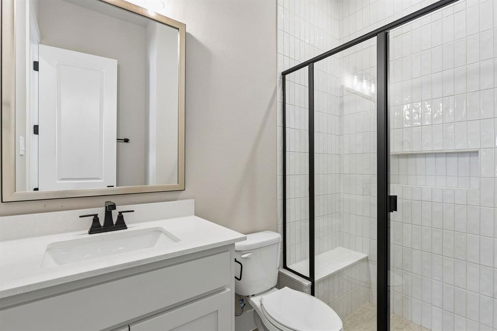 4512 Meander Way Prosper, TX 75078 - Photo 25 of 40 a bathroom with a sink a toilet and shower