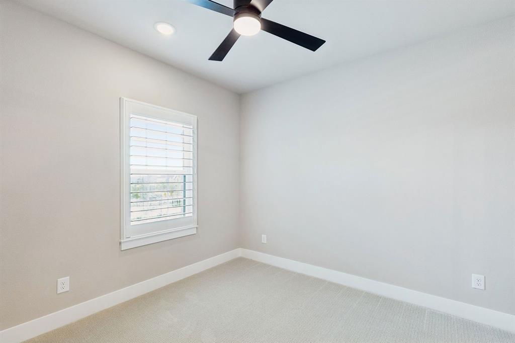 4512 Meander Way Prosper, TX 75078 - Photo 33 of 40 an empty room with a window and a fan