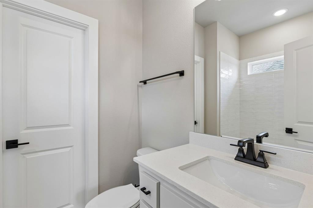 4512 Meander Way Prosper, TX 75078 - Photo 34 of 40 a bathroom with a sink a toilet and a mirror