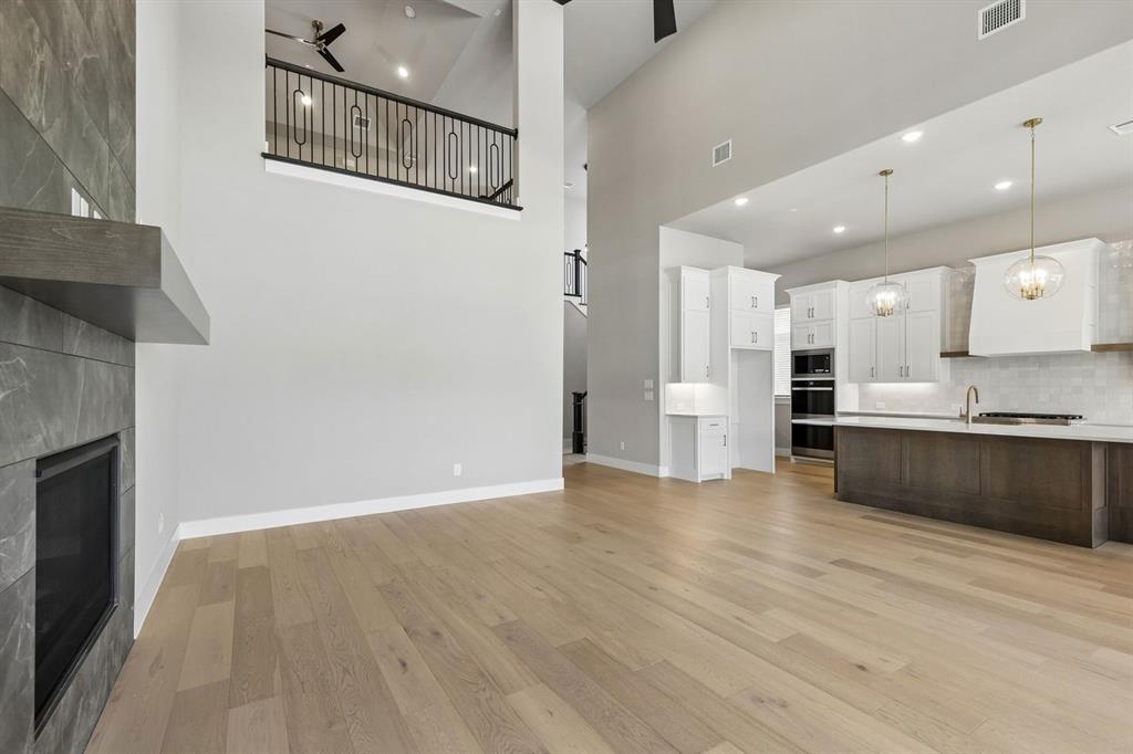 4512 Meander Way Prosper, TX 75078 - Photo 4 of 40 a view of kitchen with stainless steel appliances cabinets and wooden floor