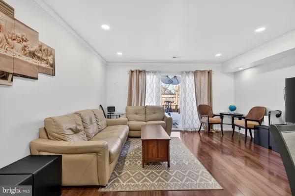 a living room with furniture wooden floor and a table