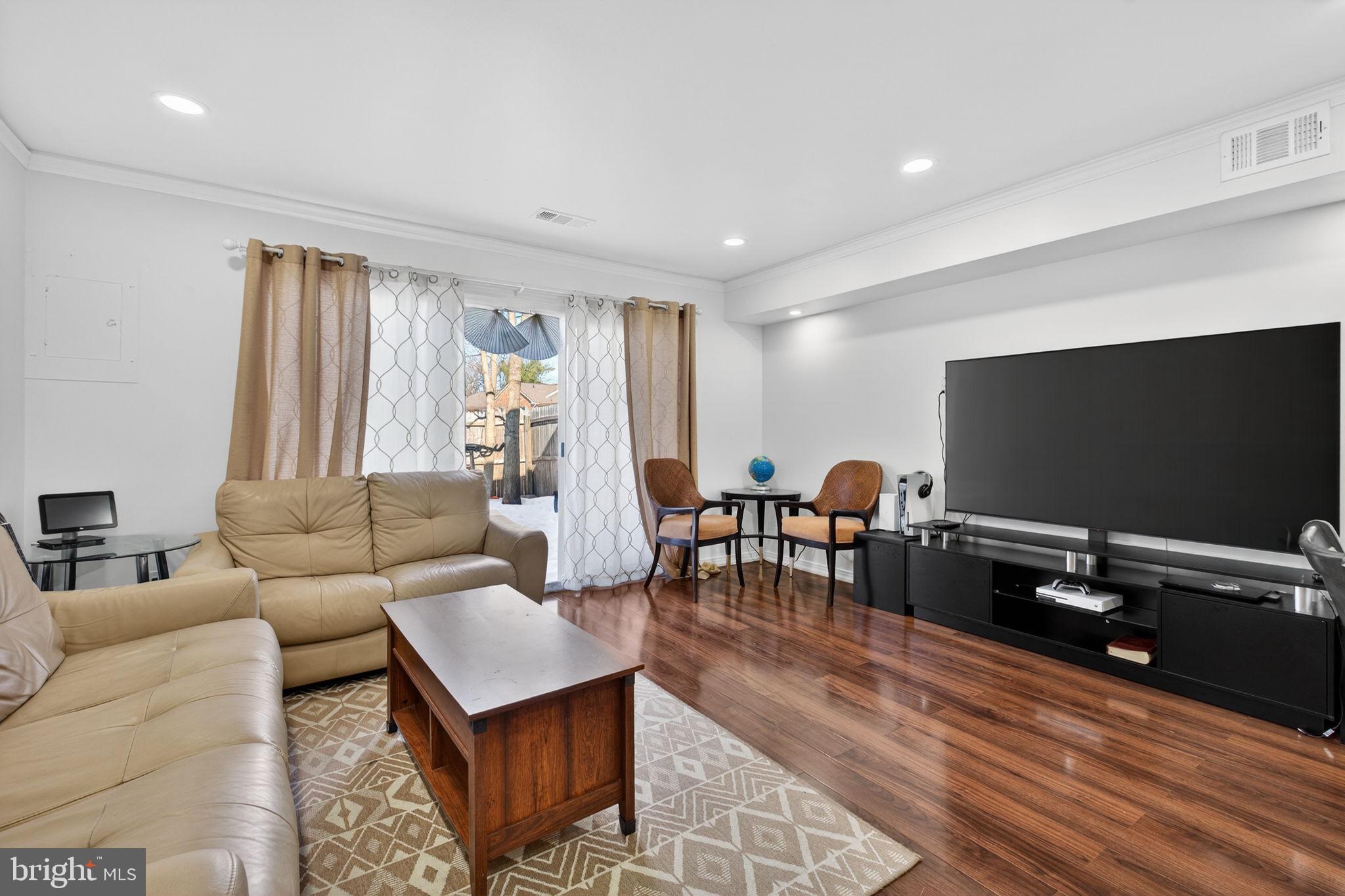 8526 Forrester Boulevard, Unit 890 Springfield, VA 22152 - Photo 12 of 24 a living room with furniture and a flat screen tv