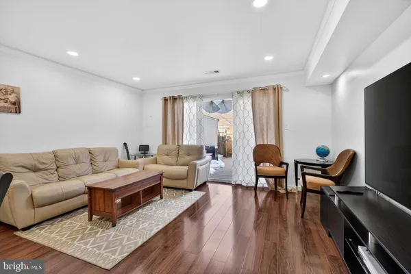 a living room with furniture rug and wooden floor