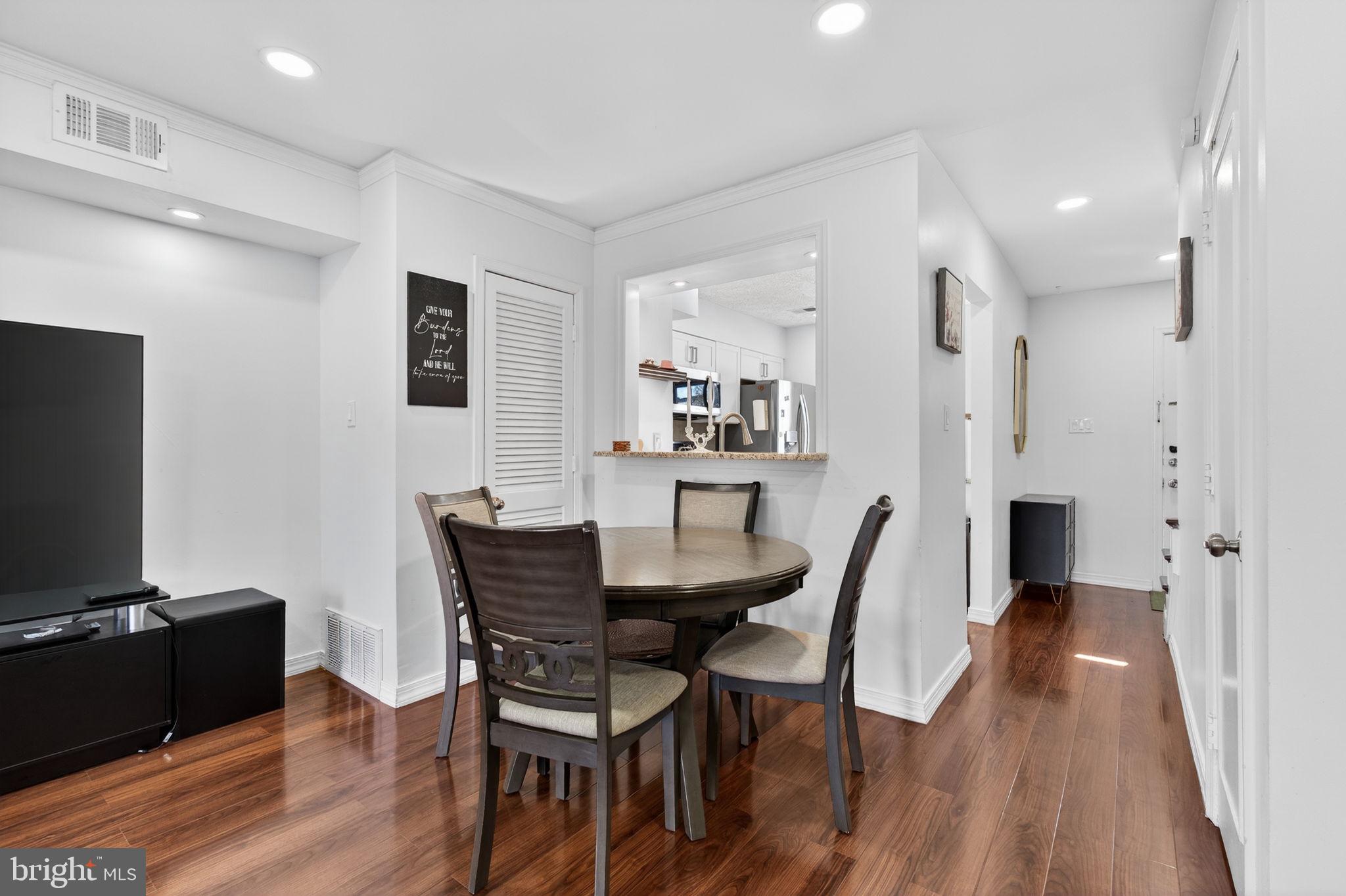 8526 Forrester Boulevard, Unit 890 Springfield, VA 22152 - Photo 14 of 24 a view of a dining room with furniture and wooden floor