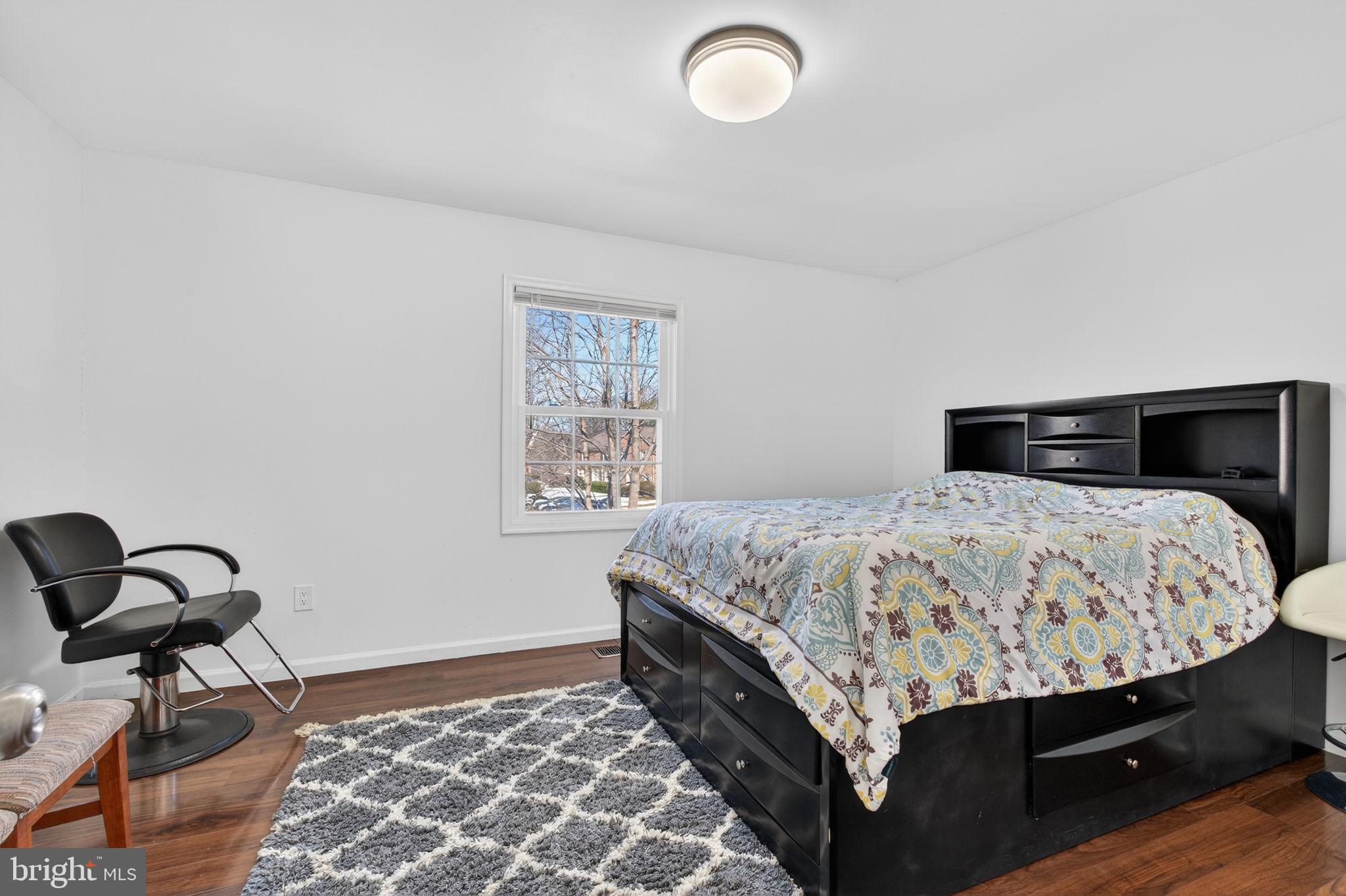 8526 Forrester Boulevard, Unit 890 Springfield, VA 22152 - Photo 17 of 24 a bedroom with a bed and dresser
