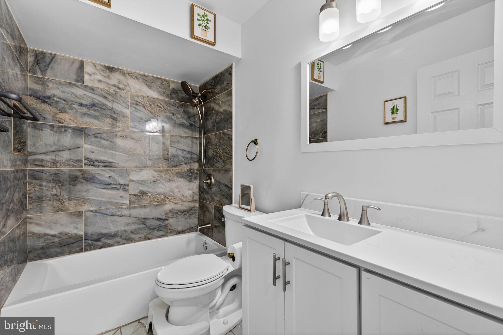 8526 Forrester Boulevard, Unit 890 Springfield, VA 22152 - Photo 19 of 24 a bathroom with a sink toilet and shower