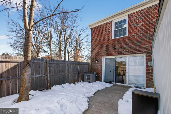 a backyard of a house with trees and wooden fence