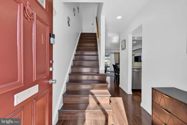 a view of entryway with wooden floor and stairs