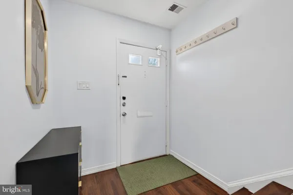 a view of small space with wooden floor and entryway