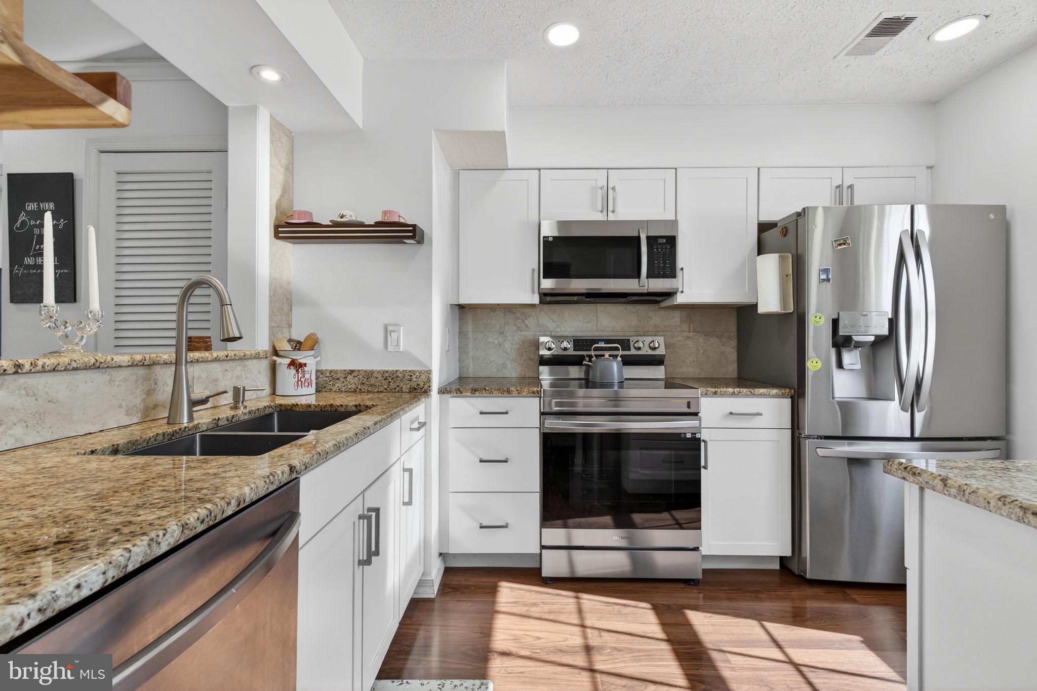 8526 Forrester Boulevard, Unit 890 Springfield, VA 22152 - Photo 5 of 24 a kitchen with a sink stove and refrigerator