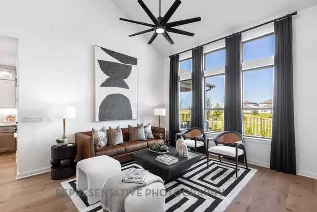 a living room with furniture a rug and a chandelier