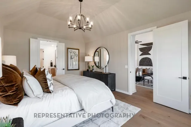 a bedroom with a large bed and a large window with balcony view