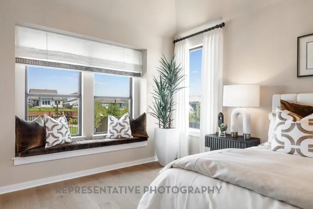 a bedroom with a large bed and a window