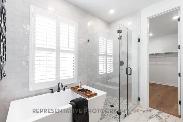 a kitchen with stainless steel appliances granite countertop a sink dishwasher a refrigerator and a stove with wooden floor