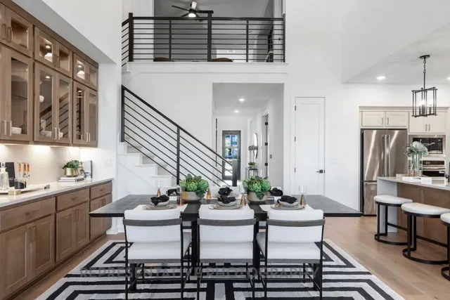 a kitchen with a table chairs stove and cabinets