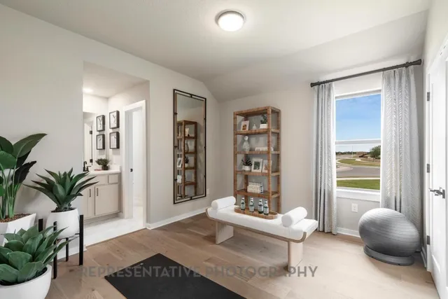 a spacious bedroom with a bed and a window