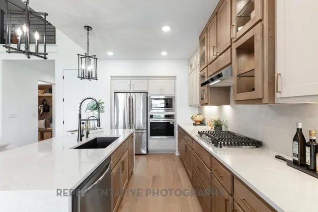 a kitchen with stove and refrigerator
