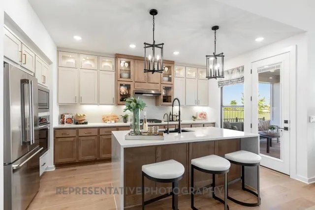 a large room with lots of white furniture and a chandelier