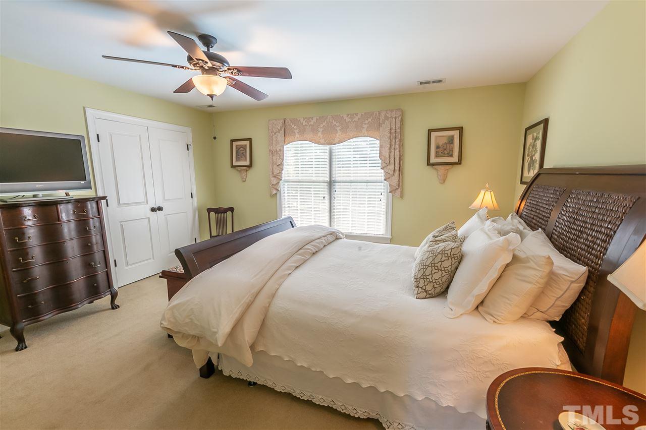 1615 Weatherford Circle Raleigh, NC 27604 - Photo 14 of 25 a bedroom with a bed and a chandelier