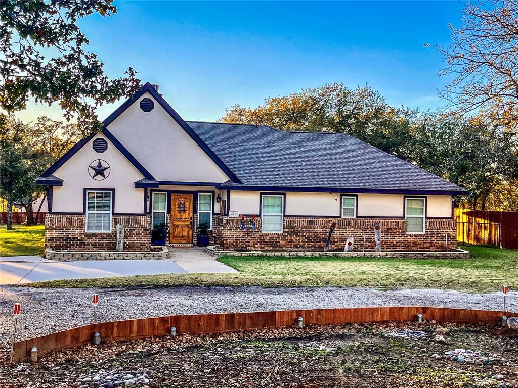 420 Sessums Road Springtown, TX 76082 - Photo 2 of 40 View of front of property featuring brick siding, a shingled roof, and stucco siding