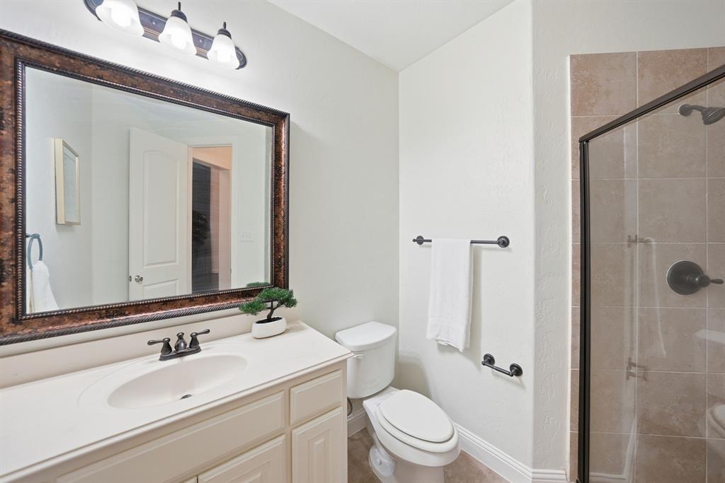 624 Sorrell Road McKinney, TX 75072 - Photo 19 of 28 a bathroom with a sink a toilet and shower
