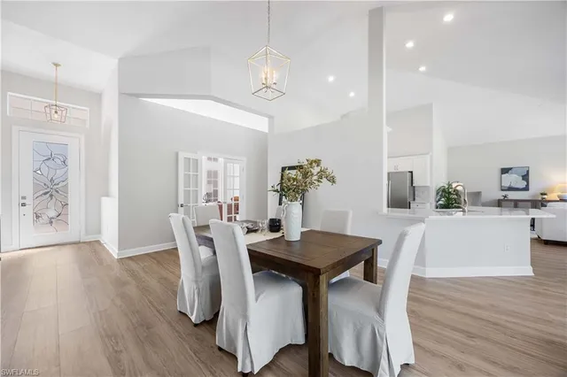 a dining room with furniture and a floor to ceiling window