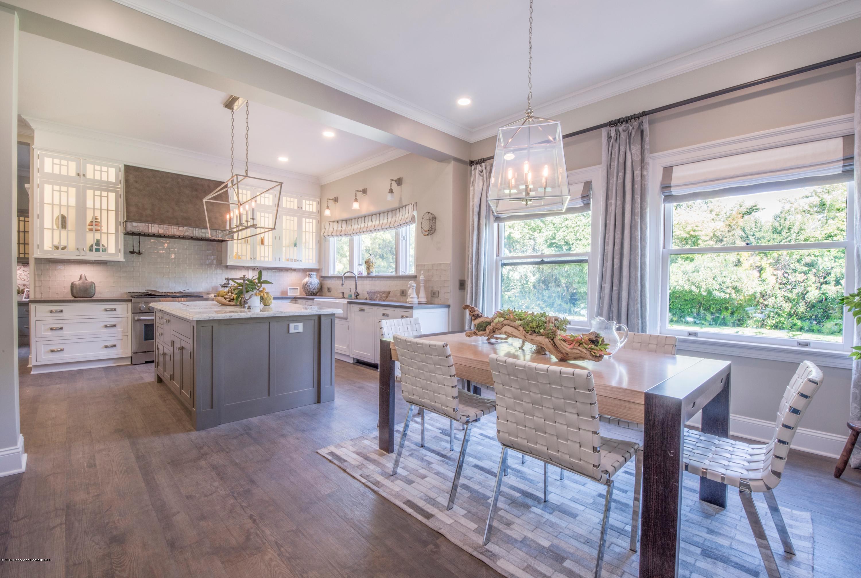 1333 Wentworth Avenue Pasadena, CA 91106 - Photo 17 of 60 a kitchen with a table chairs microwave and cabinets