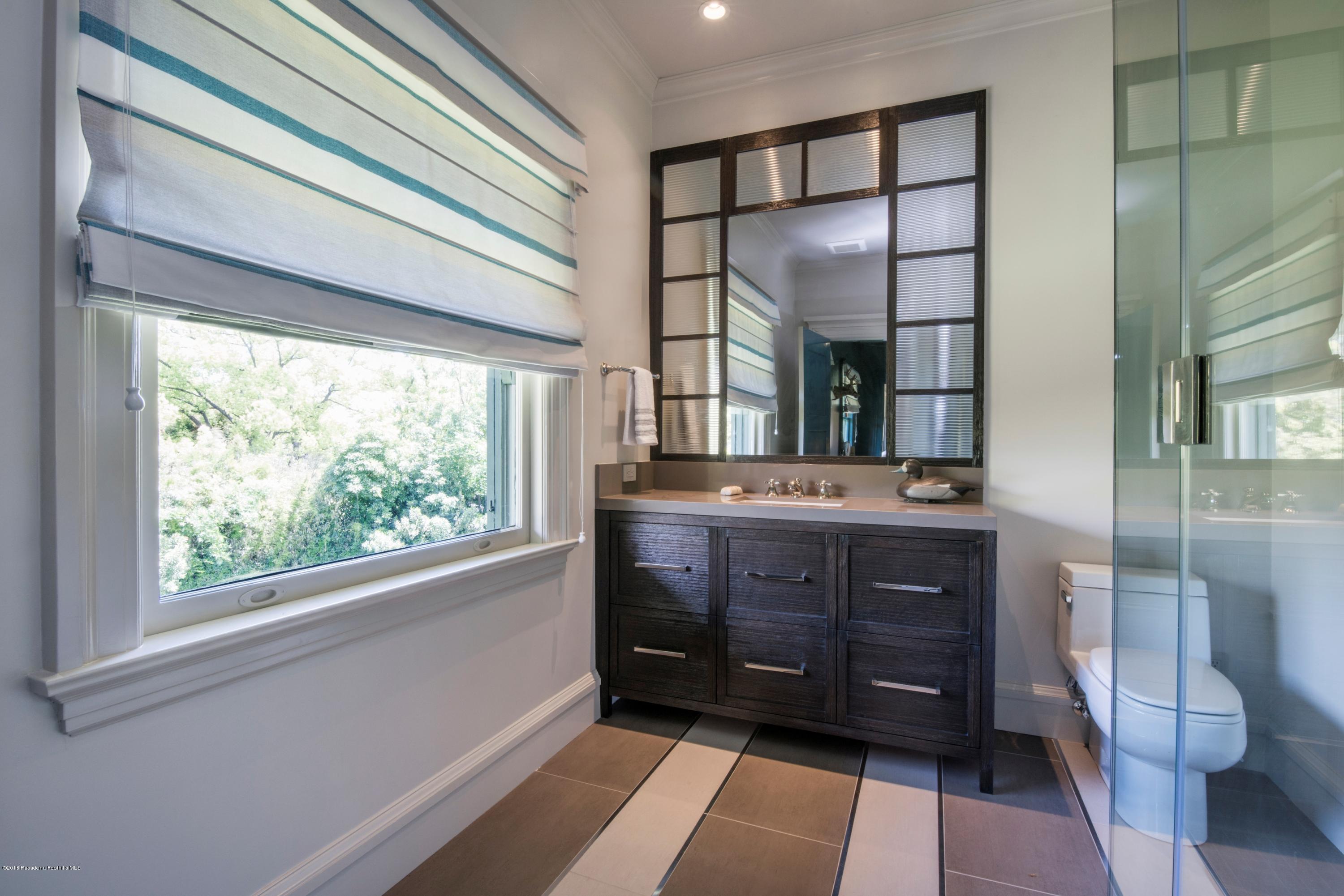 1333 Wentworth Avenue Pasadena, CA 91106 - Photo 30 of 60 a bathroom with a sink a mirror and a toilet