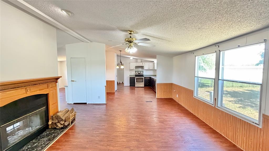 3789 Jacobs Lane Kaufman, TX 75142 - Photo 5 of 33 a view of a living room with furniture a fireplace and wooden floor