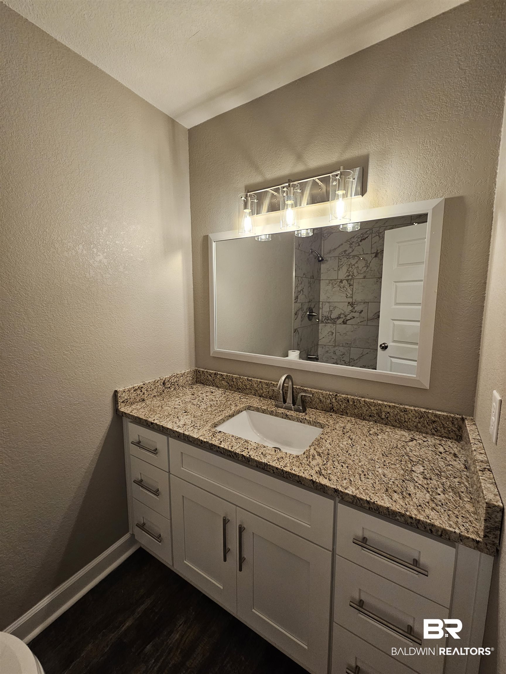 138 Wicker Way Daphne, AL 36526 - Photo 27 of 32 Full bathroom with a textured wall, vanity, a shower, and dark wood-type flooring
