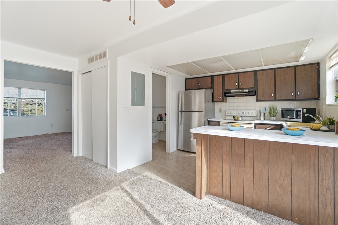 5414 Lamme Road Dayton, OH 45439 - Photo 13 of 32 This bright kitchen and living area features a practical layout with direct access to a nearby bathroom.