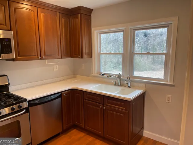 a kitchen with a sink stove and cabinets