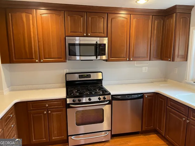 a kitchen with wooden cabinets and a stove top oven
