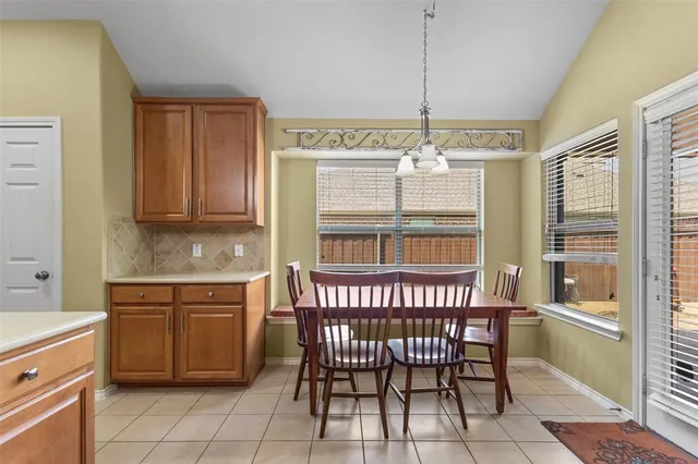 a kitchen with a window a sink and chairs