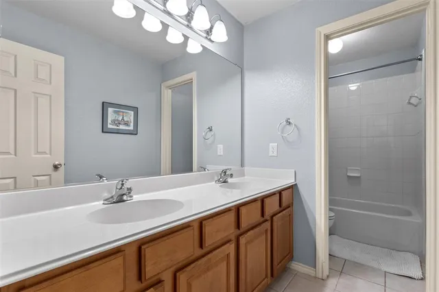 a bathroom with a sink double vanity granite tub and shower