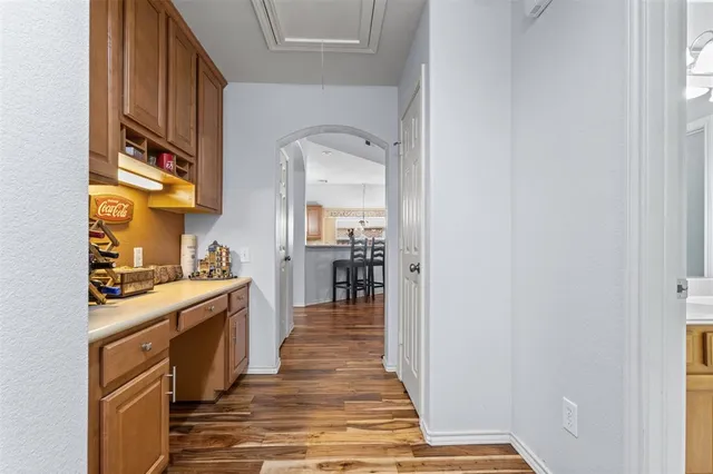 a kitchen with wooden floor and cabinets