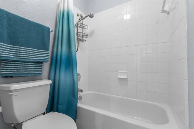 a bathroom with a toilet and a bathtub