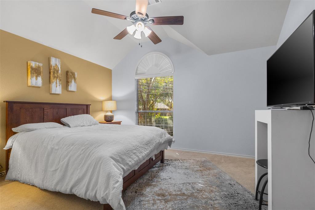 12334 Blue Ridge Drive Frisco, TX 75033 - Photo 20 of 32 a bedroom with a bed and a flat screen tv