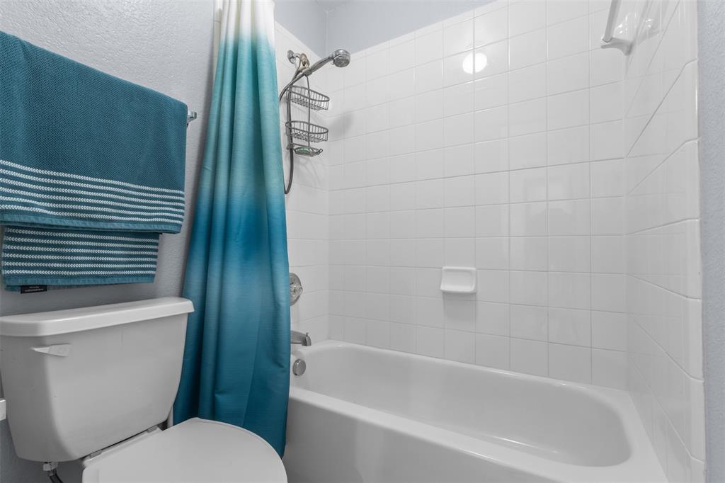 12334 Blue Ridge Drive Frisco, TX 75033 - Photo 21 of 32 a bathroom with a toilet and a bathtub