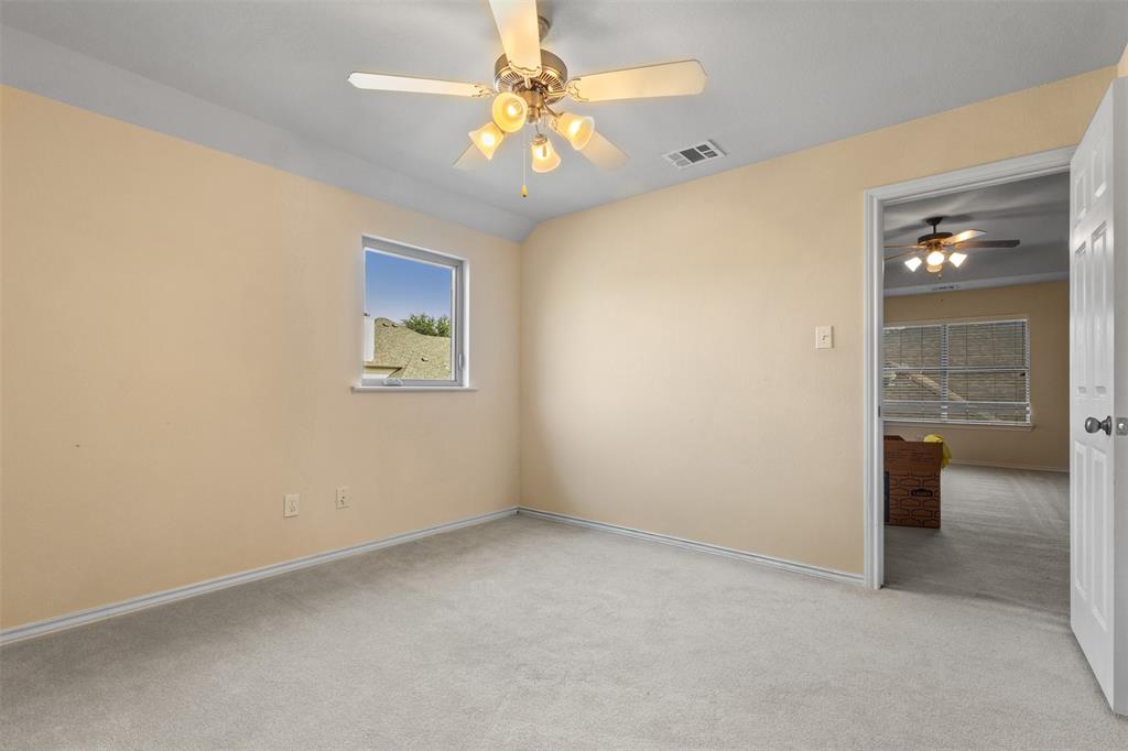 12334 Blue Ridge Drive Frisco, TX 75033 - Photo 24 of 32 an empty room with a chandelier fan and a window