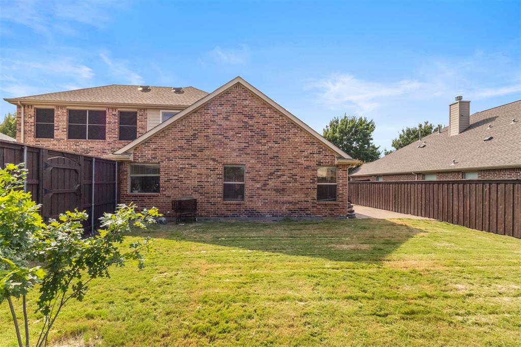 12334 Blue Ridge Drive Frisco, TX 75033 - Photo 26 of 32 a view of a house with a yard
