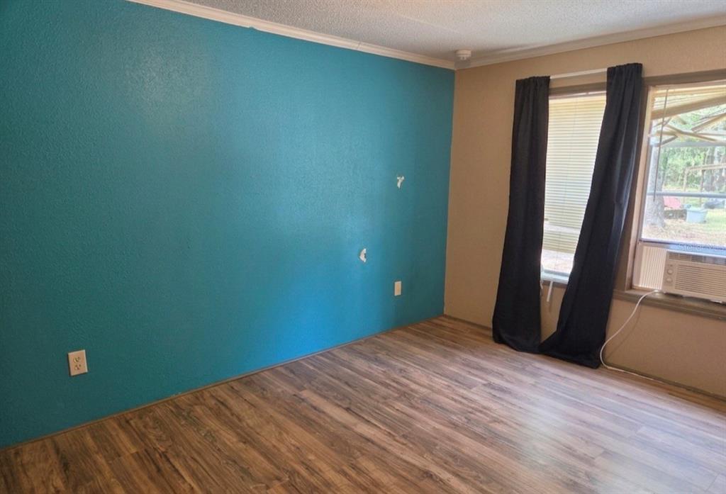 4738 Southwest 166th Court Road Ocala, FL 34481 - Photo 9 of 14 a view of an empty room with wooden floor and a window