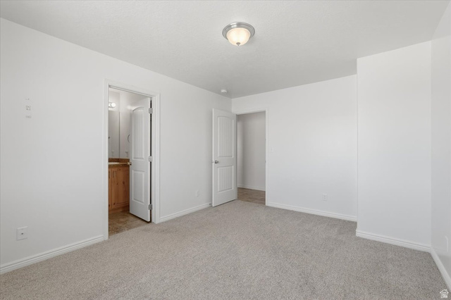 1218 Moonlight Drive Elk Ridge, UT 84651 - Photo 11 of 44 Unfurnished bedroom featuring light carpet and connected bathroom