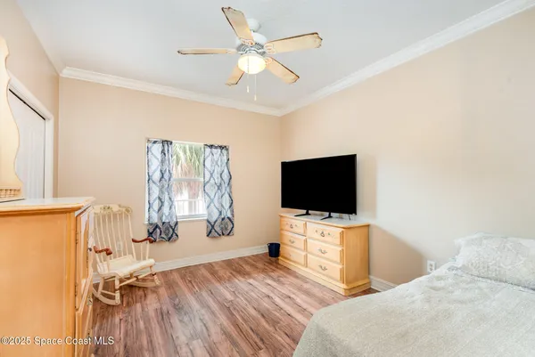 a bedroom with a bed and a ceiling fan