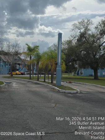 a view of road with card parked on side and road