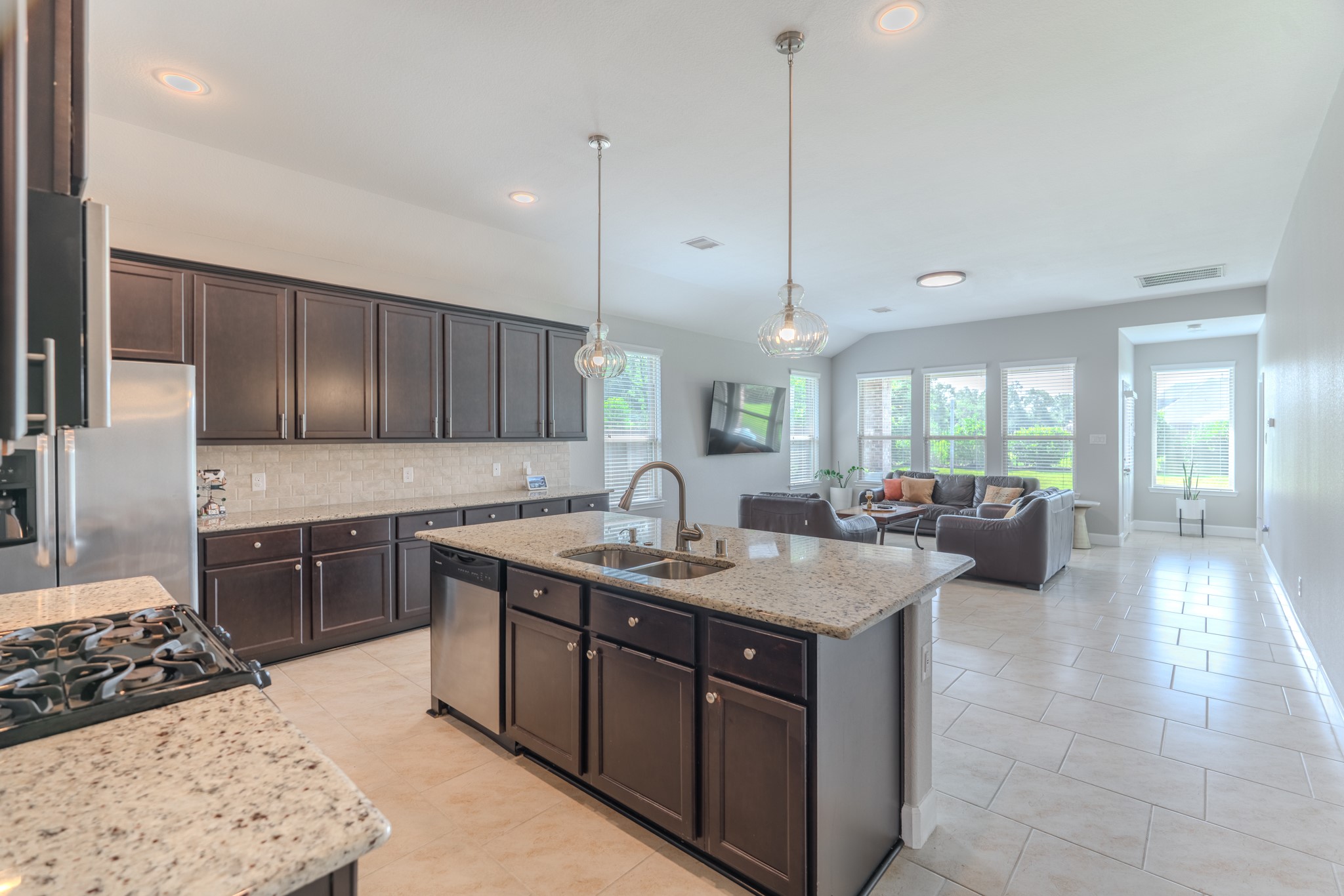 24322 North Newcastle Bay Trail Spring, TX 77389 - Photo 1 of 50 a kitchen with a stove a sink a refrigerator and chairs