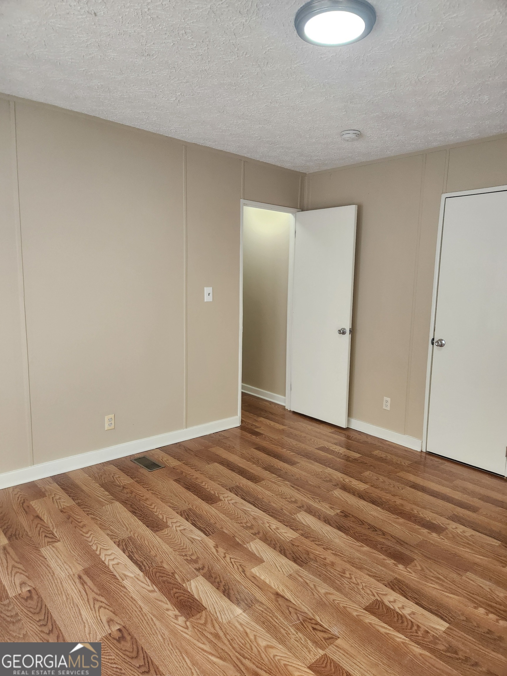 88 Dry Creek Road Danielsville, GA 30633 - Photo 14 of 20 a view of an empty room and wooden floor